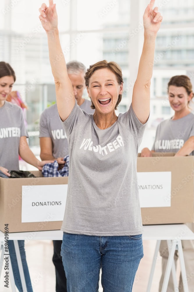 Cheering female volunteer in front of colleagues Cheering female volunteer in front of colleagues
