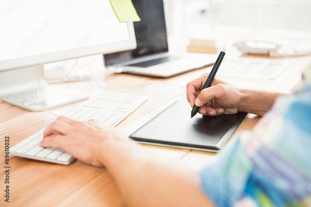 Fotografie Graphic designer using computer and digitizer