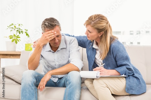 Concerned therapist comforting male patient