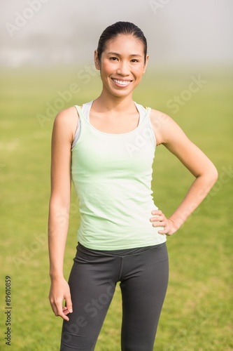 Smiling sporty woman with hand on hip © WavebreakMediaMicro