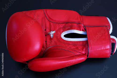 Gold Wedding Rings on Red Boxing Glove. Sport and Family © Annatamila