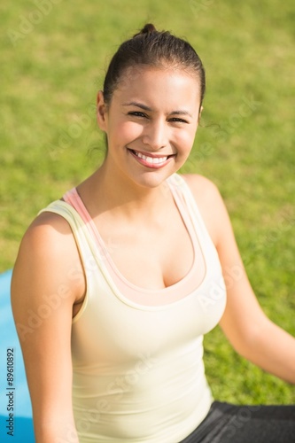 Smiling fit woman looking at camera