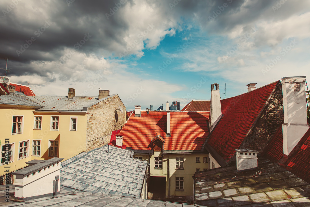Roofs and clouds over European city skyline
