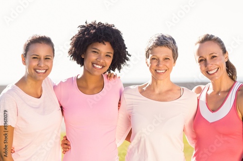 Smiling women wearing pink for breast cancer