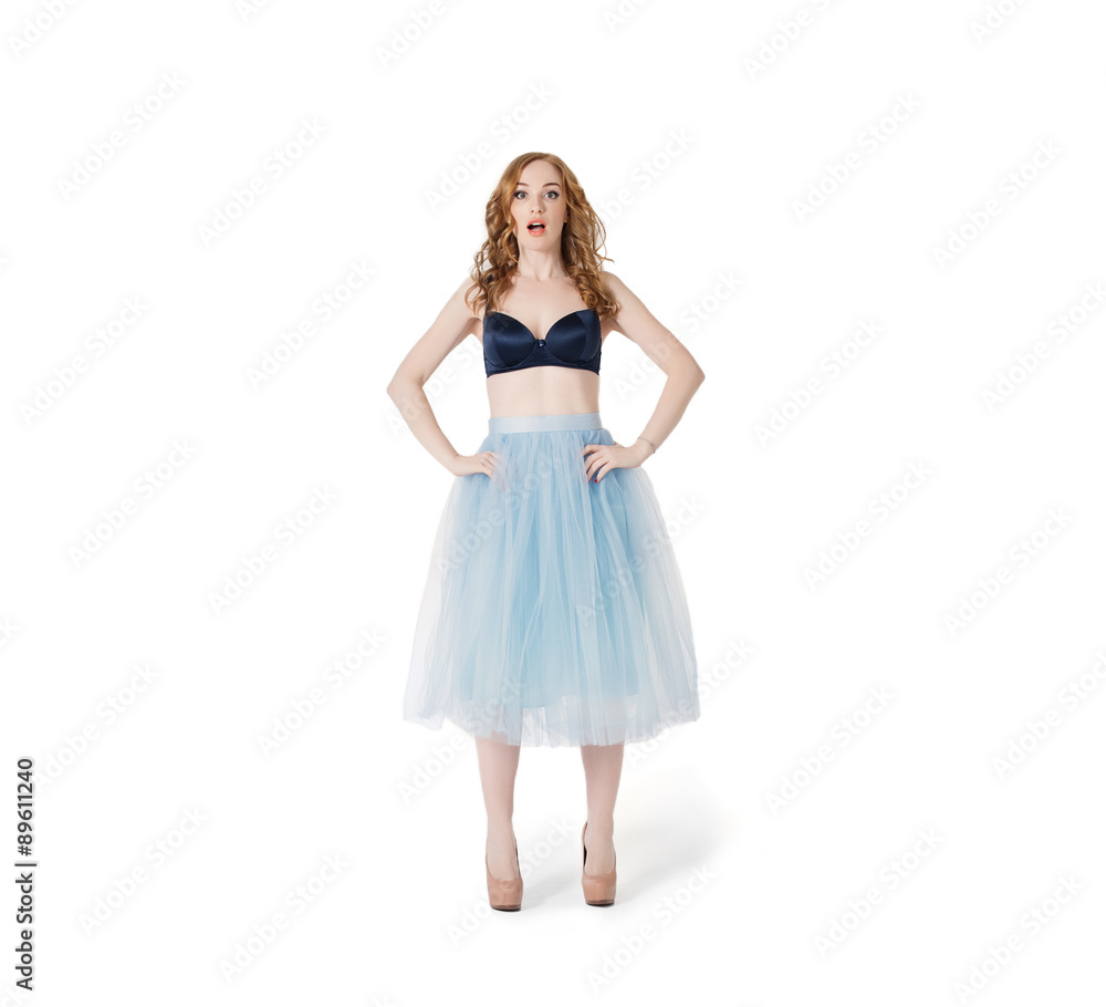 Surprised and confused Yang Red Hair Fashion Woman in underwear and lush skirt isolated on white background. Empty wardrobe problem