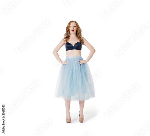 Surprised and confused Yang Red Hair Fashion Woman in underwear and lush skirt isolated on white background. Empty wardrobe problem