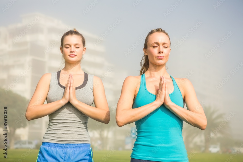 Peaceful sporty blondes doing yoga together Peaceful sporty blondes doing yoga together