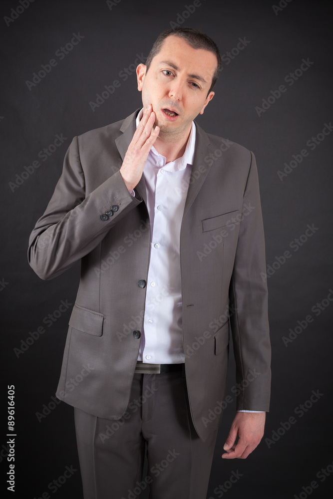 Handsome man doing different expressions in different sets of clothes: toothache Handsome man doing different expressions in different sets of clothes: toothache
