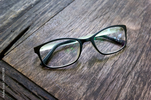 black fashion glasses on wood background