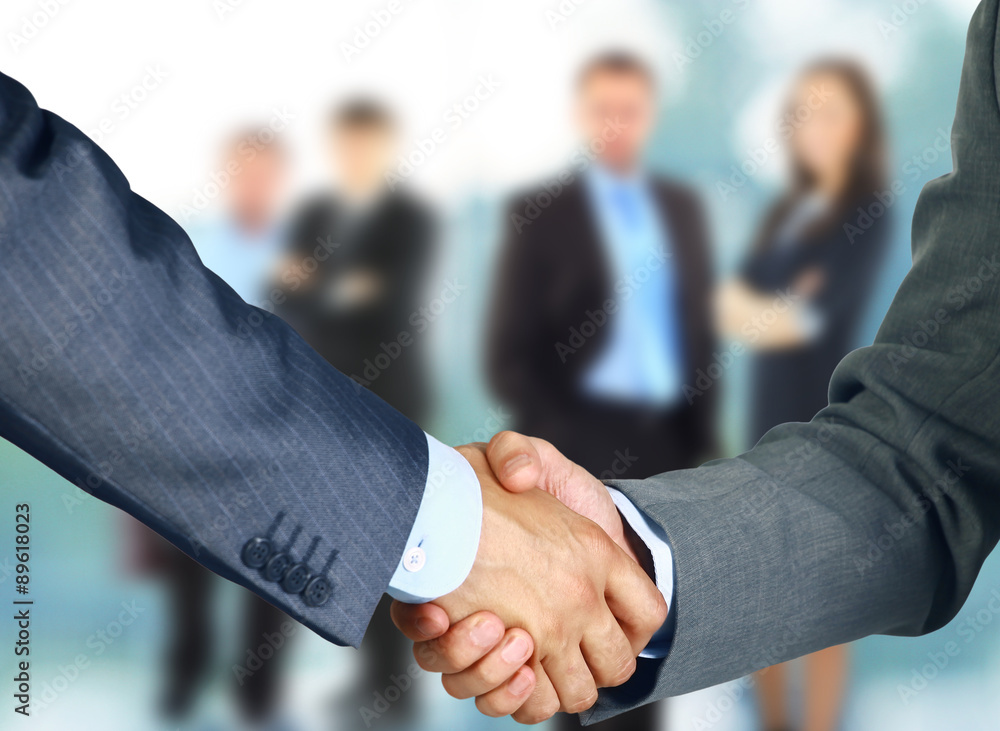 Business handshake and business people Business handshake and business people