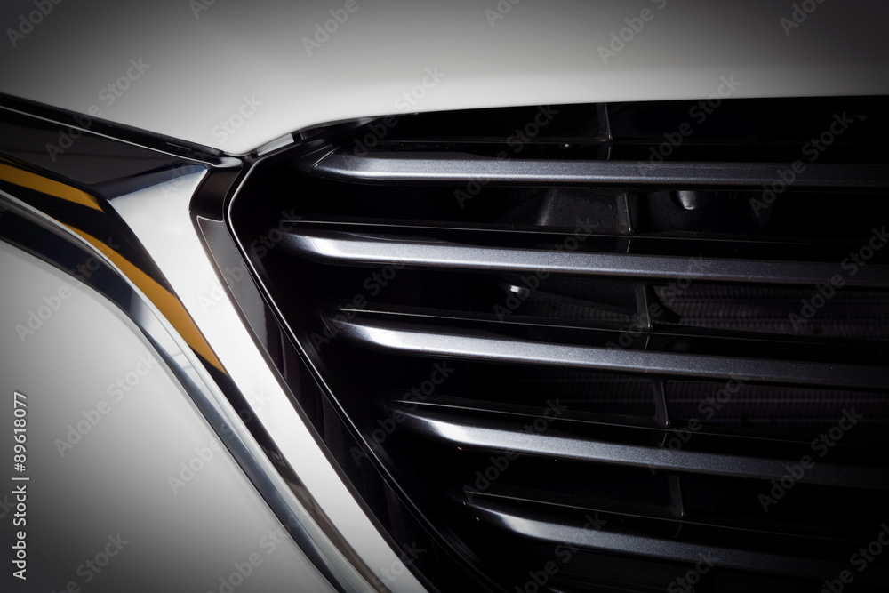 Modern luxury car close-up of grille. Expensive, sports auto detailing