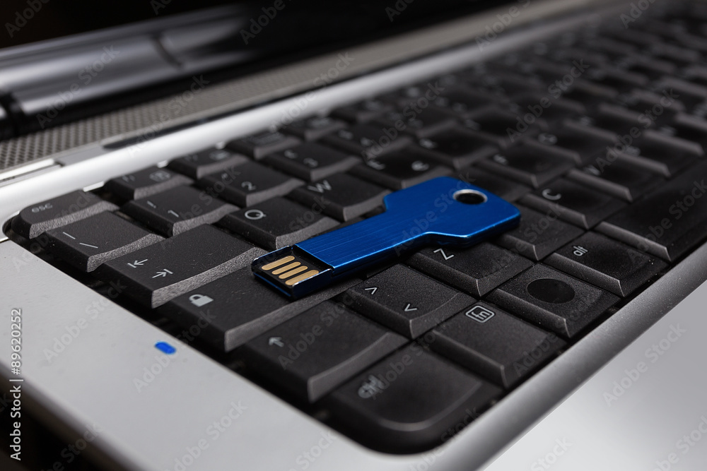 Blue usb key on laptop keyboard
