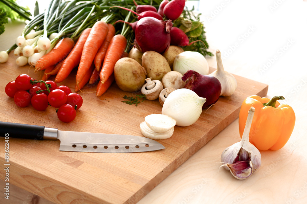 Pile of organic vegetables on a rustic wooden table Pile of organic vegetables on a rustic wooden table