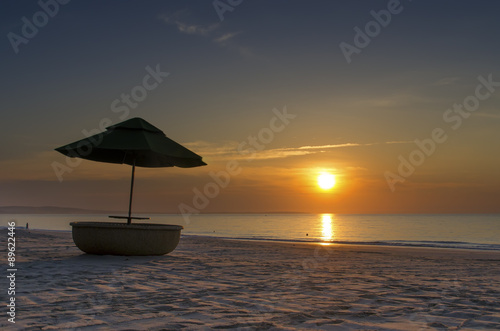 Beach umbrella at sunrise © cherrytomato