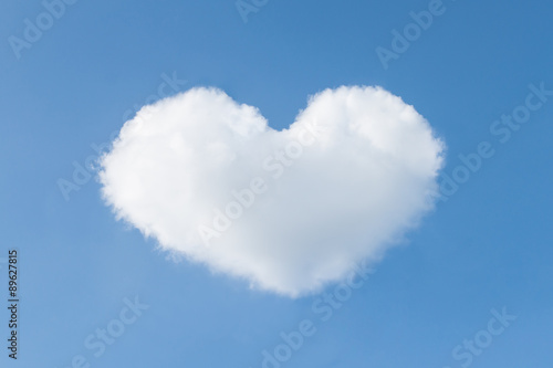 Heart shaped cloud in the blue sky. Valentines day background