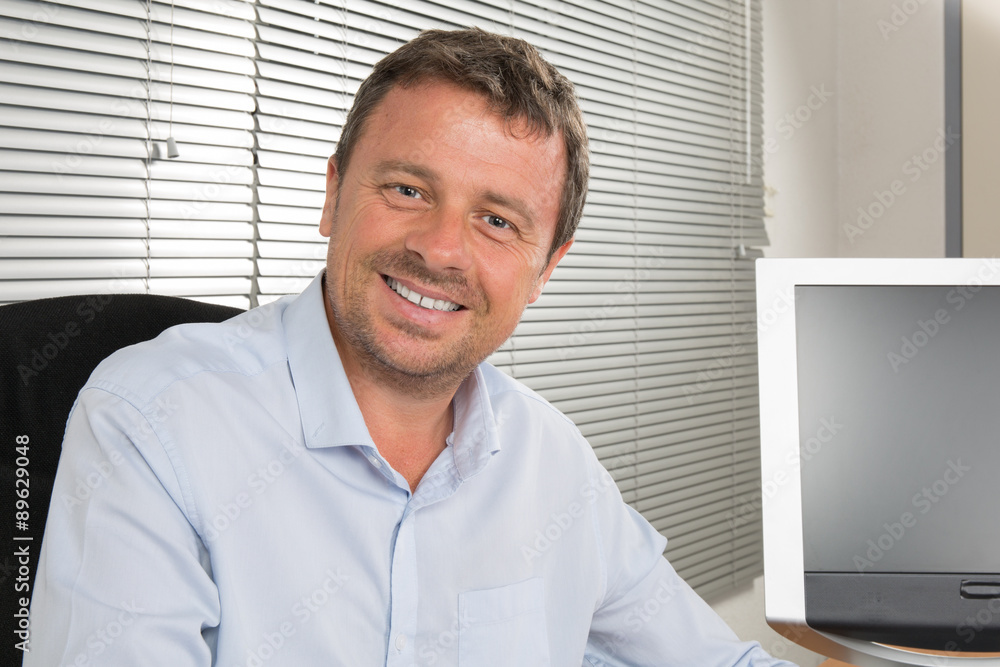 Closeup portrait of smiling businessman wearing a blue shirt Closeup portrait of smiling businessman wearing a blue shirt