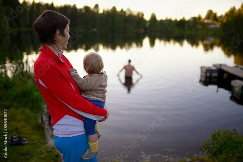 Typical Russian rural family on the forest lake photo