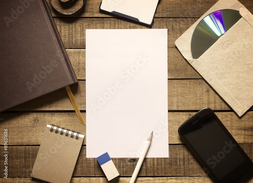 Notepaper and stationery office equipment on wooden background,