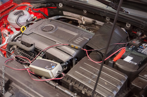 Repairing engine inside car hood © vchalup