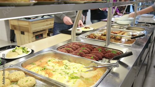 Lunch in the canteen. The waiter serves visitors.
