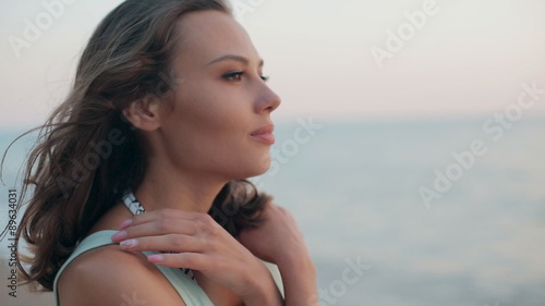 Wallpaper Mural Thoughtful and beautiful girl standing near sea at sunset and Torontodigital.ca