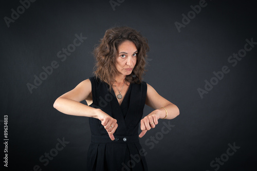 Beautiful woman doing different expressions in different sets of clothes: thumbs down