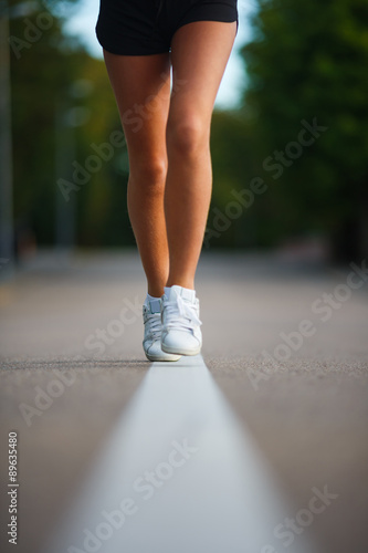 Girl running in a city on the road