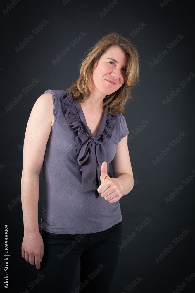 Beautiful woman doing different expressions in different sets of clothes: thumbs up Beautiful woman doing different expressions in different sets of clothes: thumbs up