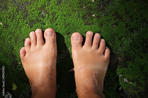 Selfie of woman feet with grass moss