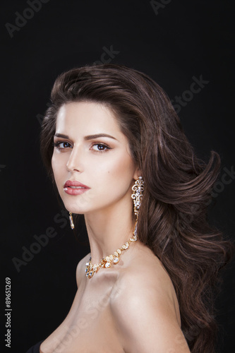 portrait of a beautiful brunette girl with luxury accessories