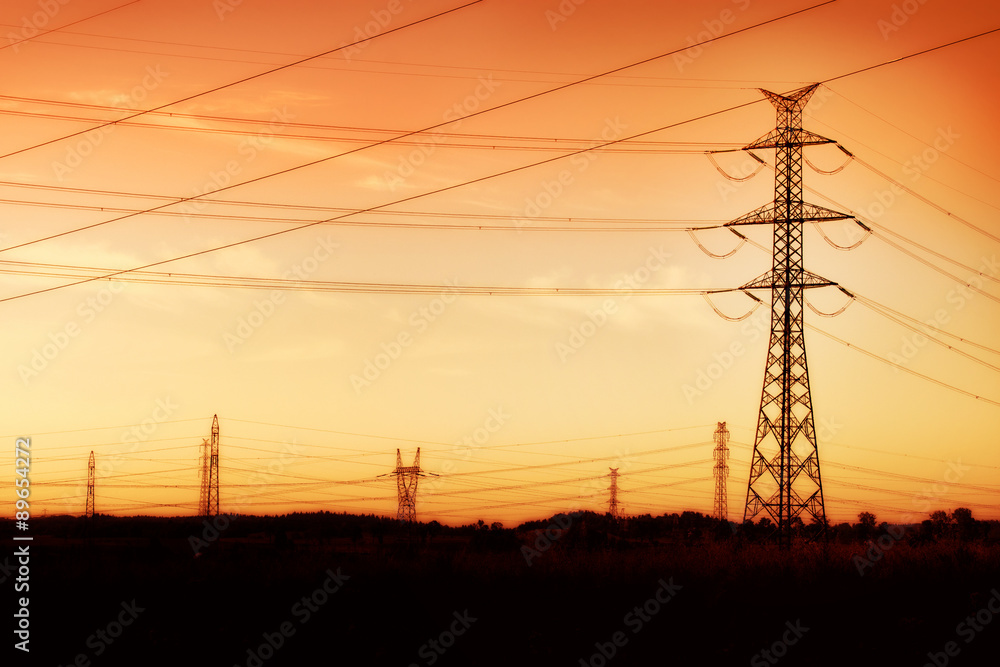 silhouette of high voltage electrical pole structure and cables. Waving hot air.