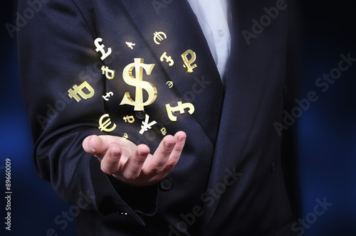 Currency gold symbols in a man hand