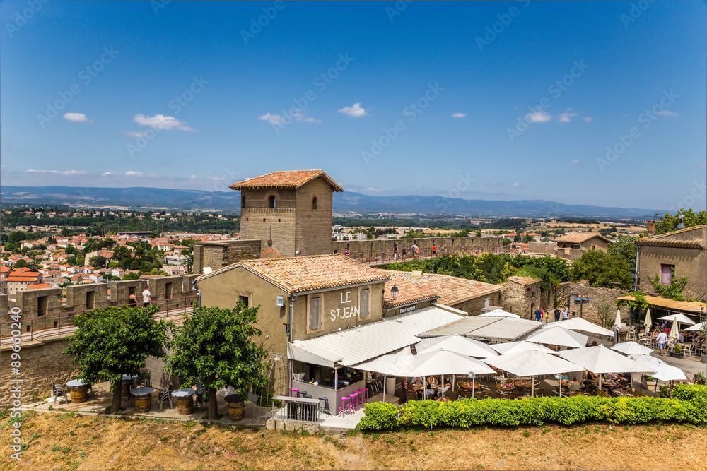 Carcassonne, France. Summer restaurant in the upper town on the background of the fortifications