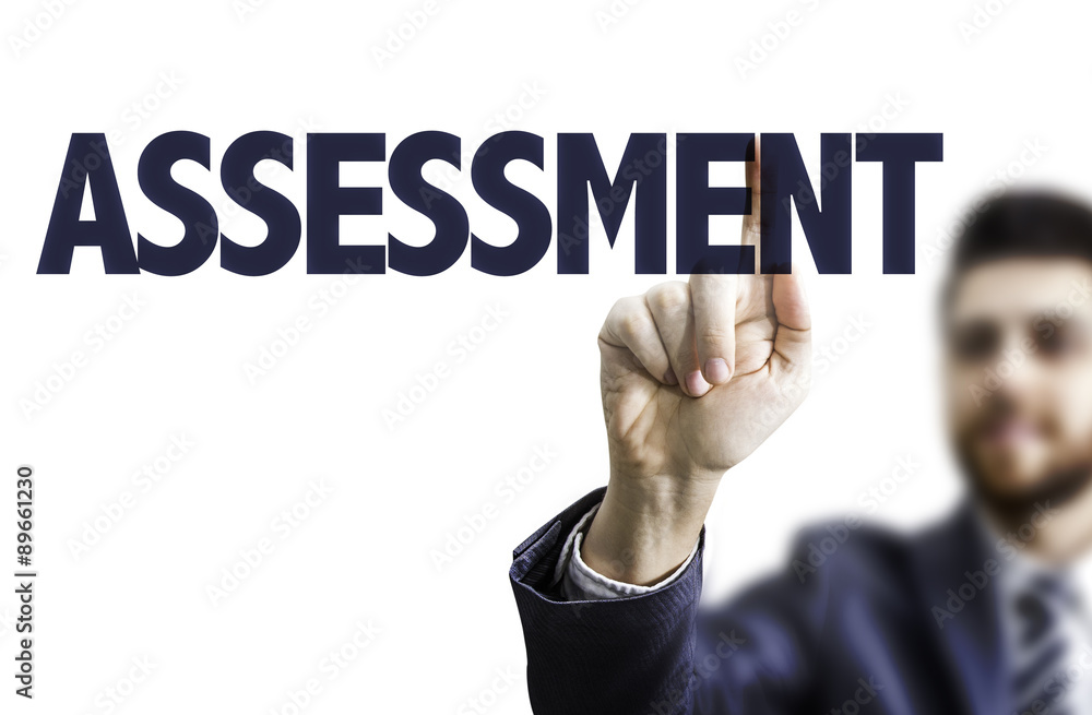 Business man pointing the text: Assessment Business man pointing the text: Assessment