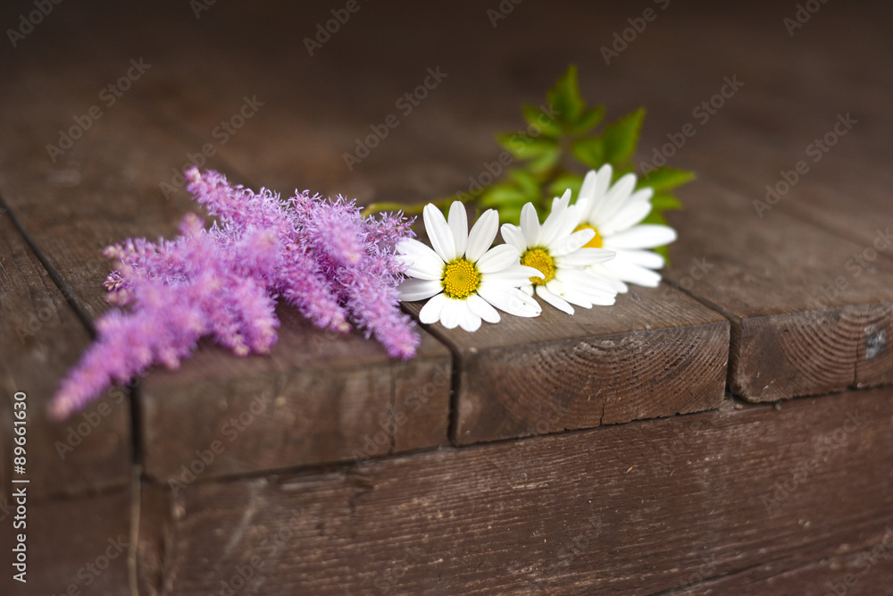 Fototapeta premium Flowers on wooden background