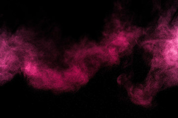 Pink dust powder smoke explosion on black background