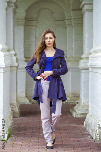 Portrait of a beautiful sexy young woman in dark blue coat