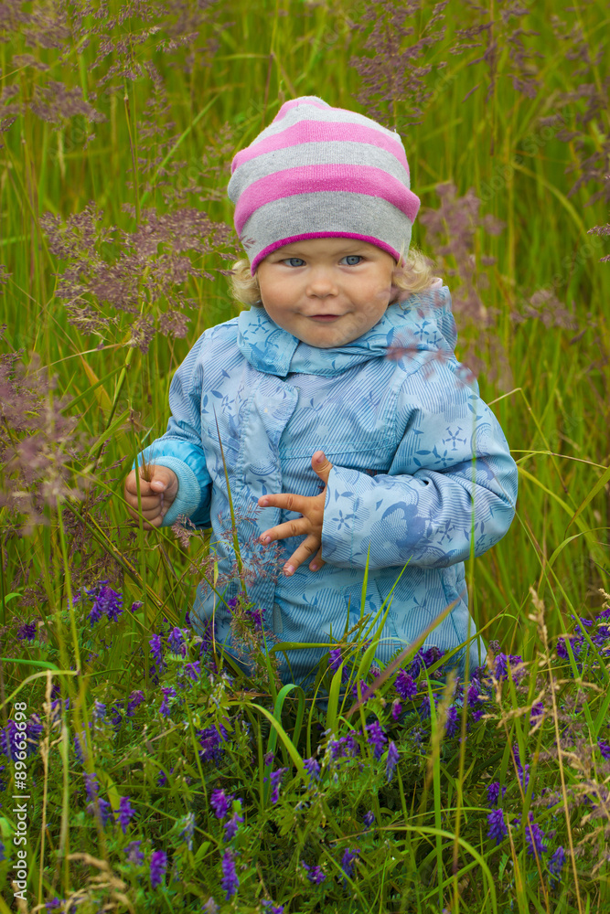 Girl walking in the bush and collect the flowers. Girl walking in the bush and collect the flowers.