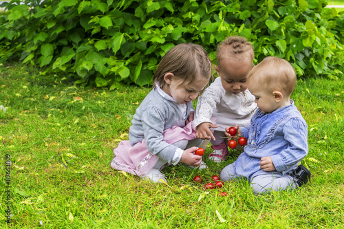 Three little girls playing in the garden