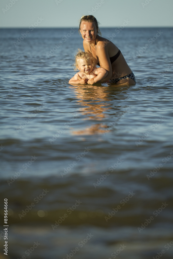 Mother with the children in the sea. summer holiday by the ocean. Lifestyle Mother with the children in the sea. summer holiday by the ocean. Lifestyle