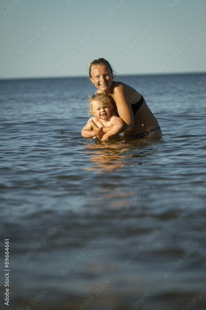 Mother with the children in the sea. summer holiday by the ocean. Lifestyle Mother with the children in the sea. summer holiday by the ocean. Lifestyle