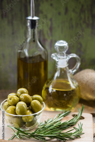 Green Olives with Bottles of Olive Oil