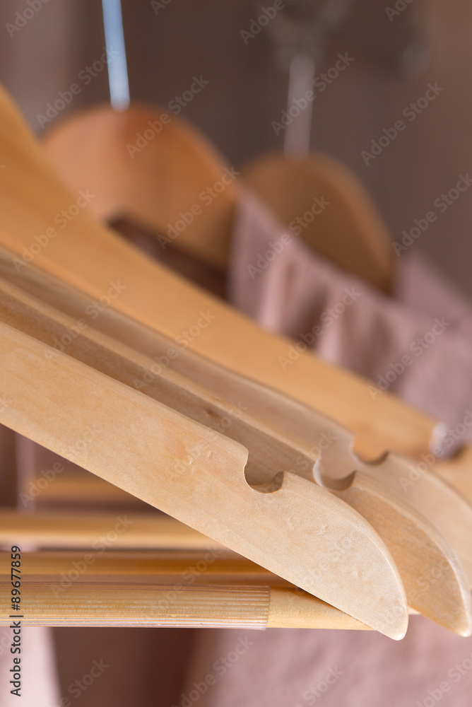 bathrobe with wooden hangers in wardrobe