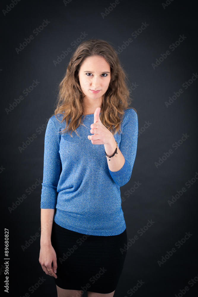 Beautiful woman doing different expressions in different sets of clothes: gun sign Beautiful woman doing different expressions in different sets of clothes: gun sign