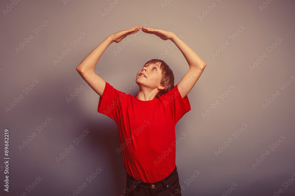 boy teenager European appearance in a red shirt folded his arms boy teenager European appearance in a red shirt folded his arms