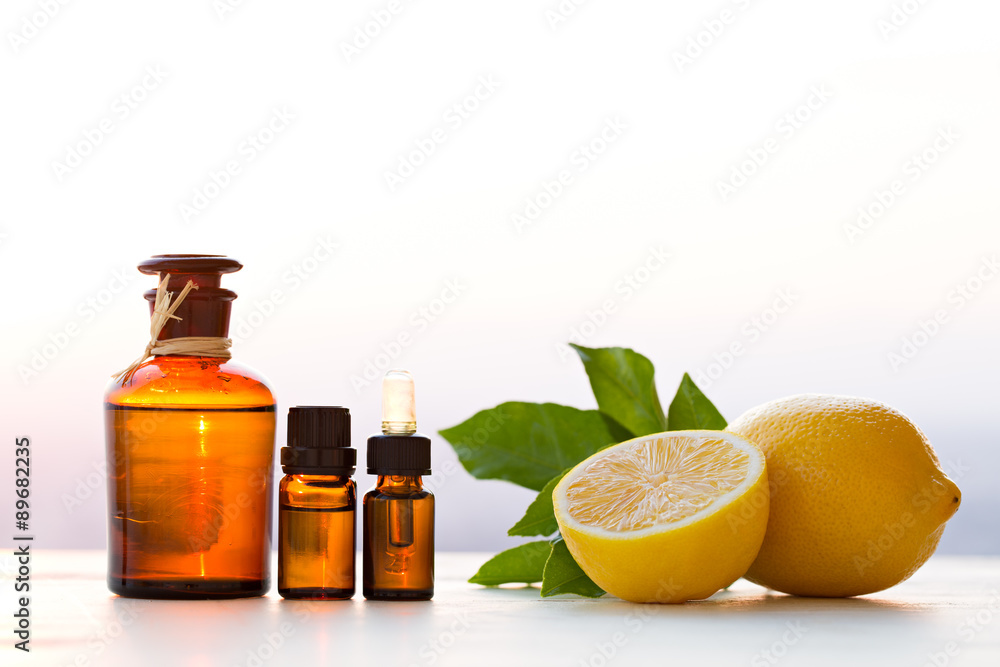 Lemon essential oils in bottles with lemon Lemon essential oils in bottles with lemon