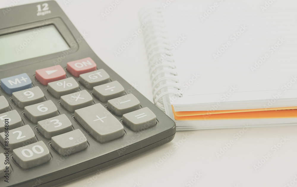 close up of calculator and note book, process color. close up of calculator and note book, process color.