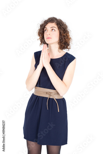 Beautiful Hispanic woman doing different expressions in different sets of clothes: praying