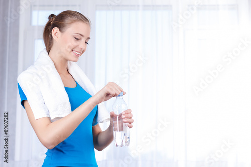Pleasant girl drinking water 