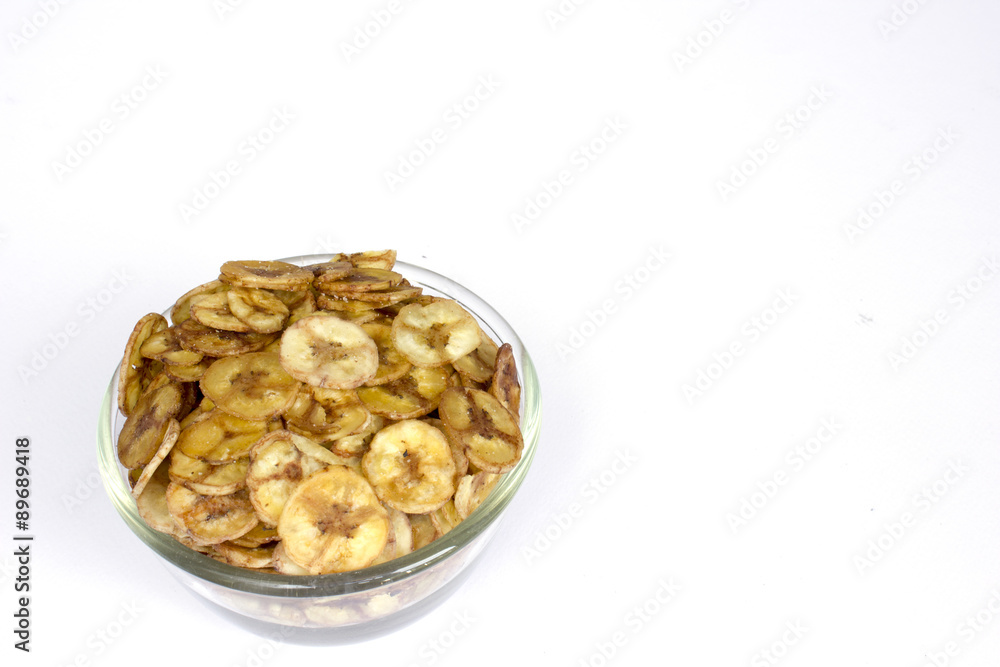 Dried banana slice coated with sugar and salt in cup isolated on white background Dried banana slice coated with sugar and salt in cup isolated on white background